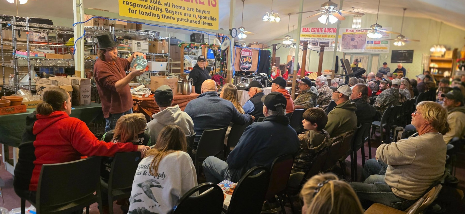 JP auctioning indoors to a full crowd